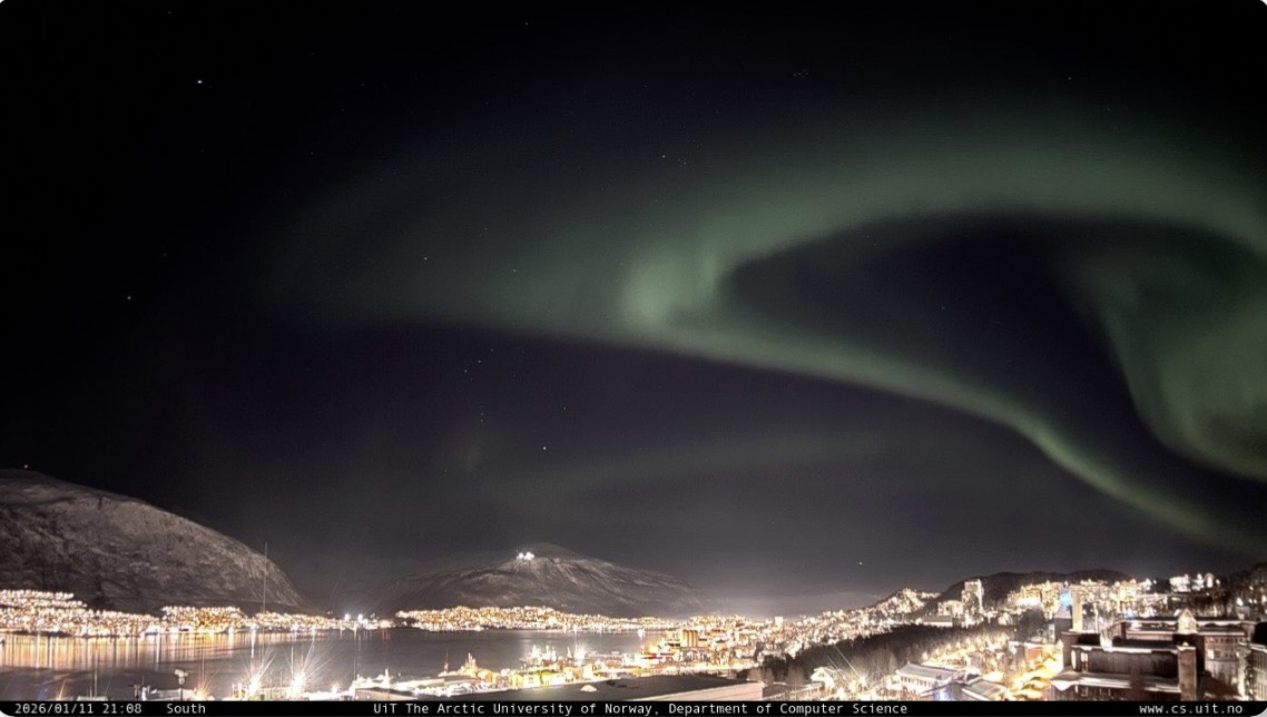 StormCast camera feed showing green Northern Lights visible over Tromsø
